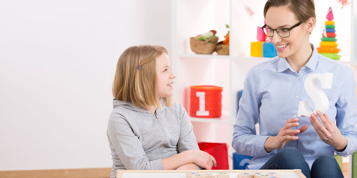 A child and a Speech-Language Therapist.